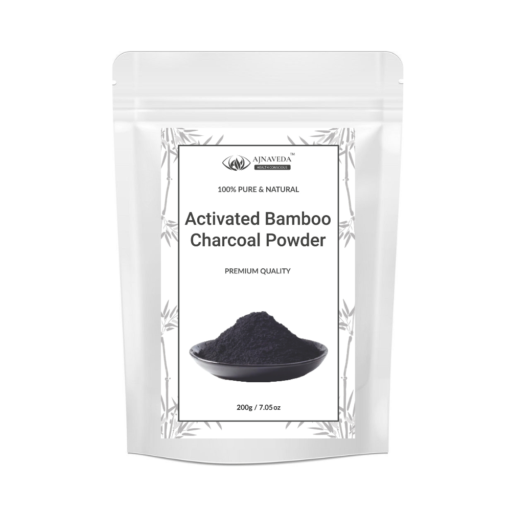 AJNAVEDA Activated Bamboo Charcoal Powder in eco-friendly packaging, displayed with a smooth, dark texture that emphasizes its purifying properties. Ideal for detoxifying the skin and hair, it’s shown in its pure, natural form.