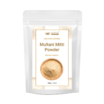 AJNAVEDA Multhani Mitti Powder (Fuller's Earth) in eco-friendly packaging, showcasing its fine, light brown powder. Known for its purifying properties, it deeply cleanses the skin, absorbs oil, and tightens pores