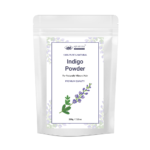 AJNAVEDA Indigo Powder in eco-friendly packaging, showcasing its fine greenish powder. This 100% natural powder provides a deep blue-black color and works effectively with henna for rich, dark hair shades